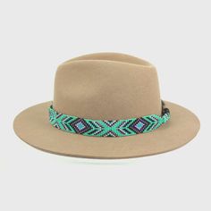 Dress up any hat with this western beaded leather hat band. Beautiful native and Navajo patterns with vibrant colors. Bring a southern charm to your old favorites with this gorgeous hat band or make your new hat even more special. Made of full grain leather (highest grade leather) and glass beads. Handmade in Brazil by artisan women. You can match your hat band with our best-selling leather beaded dog collars! Treated with beeswax, water resistant. 30 days free returns or exchange. 1-year ... Western Style Multicolor Fedora With Short Brim, Multicolor Western Fedora With Short Brim, Western Multicolor Hat Bands For Rodeo, Southwestern Style Flat Brim Hat Band For Ranch, Bohemian Fedora With Flat Crown For Ranch, Southwestern Adjustable Multicolor Hat Bands, Western Multicolor Hat Bands For Country Events, Adjustable Southwestern Multicolor Hat Bands, Southwestern Style Hat Bands For Ranch With Short Brim