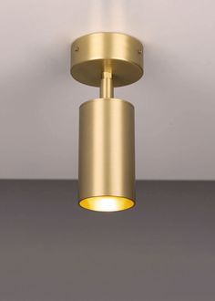 a light that is on the ceiling in a room with white walls and flooring