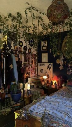 a bed room with a neatly made bed and lots of plants hanging from the ceiling