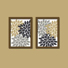 two framed artwork pieces with flowers on them in brown and white colors, one is hanging on