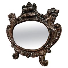 an ornately decorated mirror is shown against a white background