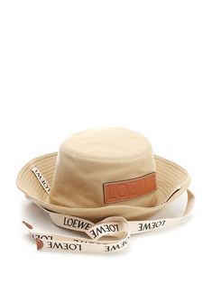 Beige cotton bucket hat from Loewe Paula' s Ibiza with logo ribbon and calfskin patch embossed Anagram calfskin patch. Luxury Hats With Logo Patch And Curved Brim, Luxury Wide Brim Summer Bucket Hat, Luxury Wide Brim Bucket Hat For Summer, Designer Adjustable Bucket Hat With Curved Brim, Loewe Paula's Ibiza, Cotton Bucket Hat, Versace Designer, Hat For Women, Wallet Bag