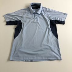 Under Armour Heat Gear Polo Golf Shirt Men's Size Large Blue. Blue Short Sleeve Golf T-shirt, Gray Short Sleeve Sports Polo Shirt, Gray Short Sleeve Polo Shirt For Sports, Blue Cotton Polo Shirt For Sports, Classic Blue Polo Shirt For Sports, Under Armour Sporty Shirt For Sports, Blue Polo Collar Shirt For Sports, Blue Crew Neck Top For Golf, Blue Collared Sports Shirt