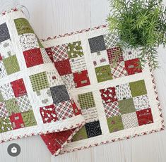 two quilted placemats sitting next to each other on top of a table