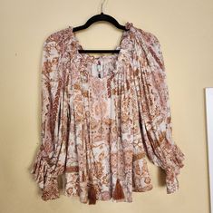 Rayon Blouse Boheme- Dress Forum Browns, Rust Beige Color Pattern Elastic At Sleeve Approximately Below Elbow Elastic Around Neckline Hassles At Bottom Of Front Tie Never Worn Shoulder To Hem-25" Shoulder To Sleeve Length 23" Cream Long Sleeve Printed Top, Long Sleeve Printed Cream Tops, White Paisley Print Blouse For Summer, Beige Long Sleeve Tops With Boho Print, Beige Boho Print Long Sleeve Tops, Flowy Cream Blouse With Floral Print, Cream Floral Print Flowy Tops, Spring Beige Boho Print Blouse, Cream Floral Print Blouse For Fall