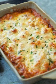 a casserole dish with cheese and herbs