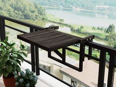 a balcony with a potted plant on it and a view of the water outside