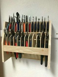 a wooden shelf holding lots of different types of tools on it's sides and the words garage organization ideas below