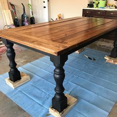 a wooden table sitting on top of a blue rug