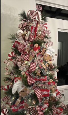 a christmas tree decorated with gingerbreads, candy canes and other holiday decorations