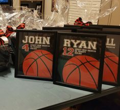 three framed basketballs are sitting on a table in front of plastic bags and other items