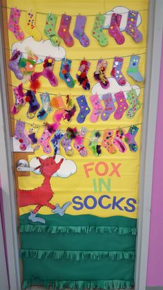 a door decorated with lots of different types of socks and letters that spell out the word fox in socks