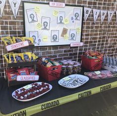 a table topped with lots of candy and candies next to a police barricade