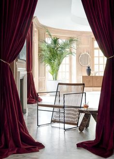 an open door leading to a living room with red curtains