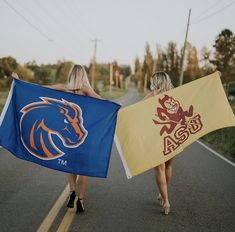 two women walking down the road holding flags