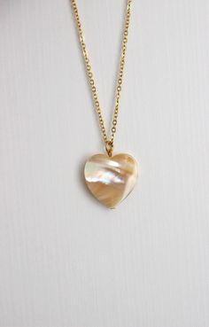 This delicate unique necklace was made of natural mother of pearl beige heart pendnat and high quality gold tone stainless steel chain with gold tone lobster claw. The chain is from lead & nickel free metal. Perfect jewelry for everyday wear and a great gift for someone special! The length of necklace is 45 cm or 17.7 inches. Other necklaces of my shop you can see here: https://www.etsy.com/shop/NaTavelli?section_id=14843046&ref=shopsection_leftnav_5 Thanks for a visit. White Heart Pendant Necklace As Gift For Her, Spiritual Round Mother Of Pearl Jewelry, Bohemian Pearl Charm Necklace Gift, Bohemian Pearl Charm Necklace As Gift, White Dainty Heart Necklace With Round Pendant, Pearl White Mother Of Pearl Shell Necklace As Gift, Pearl White Mother Of Pearl Shell Necklace Gift, Dainty White Heart Necklace With Round Pendant, Dainty White Heart Necklace