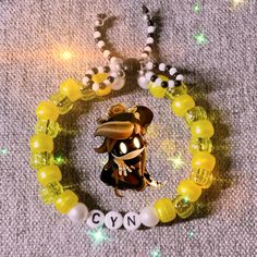 a yellow bracelet with an image of a person wearing a hat and glasses on it