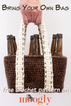 a hand holding a brown and white crochet bag with six beer bottles in it