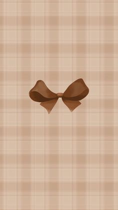 a brown bow on a tan plaid background