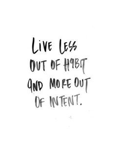 the words live less out of habit and more out of intent written in black ink