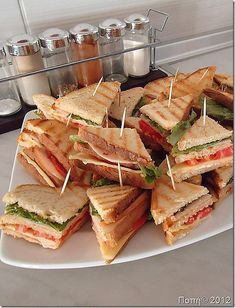 a white plate topped with lots of sandwiches