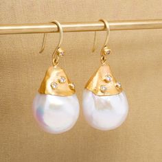 "Large, White, 54ct Baroque Pearl Earrings with Diamonds, in 24kt Gold by Prehistoric Works of Istanbul, Turkey. Length: 34mm (1.4\"); Width: 15.5mm (.6\"). Throughout the centuries, pearls have been associated with wealth, femininity, purity, wisdom, patience and peace. Due to their appearance, they have often been compared to the moon, and are said to have a calming, protective and strengthening effect on the wearer. It is also the birthstone for the month of June." Opulent Gold Earrings Gift, Opulent Gold Earrings As Gift, Opulent Gold Earrings For Gift, Opulent Gold Drop Earrings, Opulent Gold Earrings For Formal Occasions, Elegant 22k Gold Earrings, Luxury Handmade Yellow Gold Pearl Earrings, Exquisite Gold Drop Earrings, Luxury Yellow Gold Drop Pearl Earrings