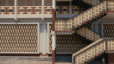 the stairs are made of metal and wood with intricate designs on them, as well as wrought iron grills