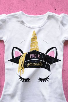 a white t - shirt with a unicorn's face and gold glitter on it