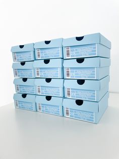 six blue boxes are stacked on top of each other in order to be used for storage