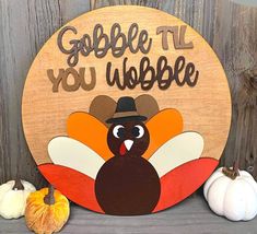 a wooden sign that says gobble it you wobble with a turkey on it