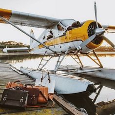 a small plane sitting on top of a wooden dock