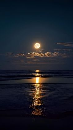 the moon is shining brightly over the ocean