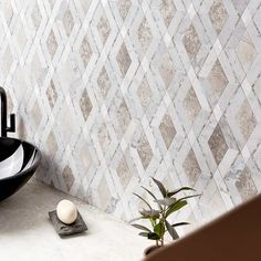 a bathroom sink sitting next to a black bowl