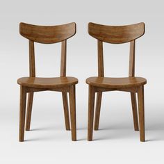 two wooden chairs sitting next to each other