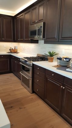 a kitchen with brown cabinets and white counter tops