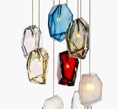 several different colored glass lights hanging from strings