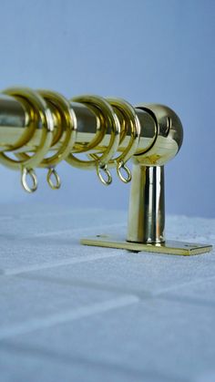 a row of gold colored handles on a white towel