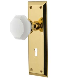 the door knob is brass and has a white ball on it's front end