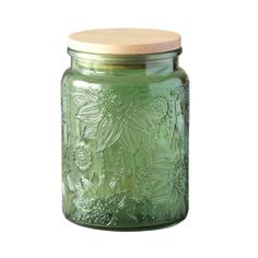 a green mason jar with a wooden lid