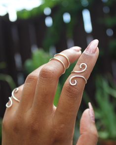 "This listing is for one (1) unique and eye-catching statement ring. The Silver Coiled Midi Ring can be ordered in any normal ring size or midi ring size. Your choice of Silver Plate or Sterling Silver wire is hand shaped in a \"S\" formation, and looks great alone and paired with other rings or alone. Due to the open shape, the ring is slightly adjustable, and great to give as a gift! Specify ring sizes during checkout: An unspecified order will revive a most midi ring size 3/4 Nickel free." Adjustable Spiral Midi Rings In Minimalist Style, Adjustable Spiral Midi Rings In Silver, Adjustable Spiral Silver Midi Rings, Adjustable Silver Spiral Midi Rings, Handmade Modern Adjustable Stackable Rings, Minimalist Spiral Metal Ring Jewelry, Modern Handmade Adjustable Stackable Rings, Modern Adjustable Handmade Stackable Rings, Adjustable Wire Wrapped Midi Rings