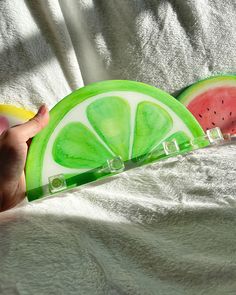 two slices of watermelon are being held by someone