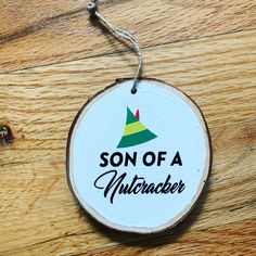 a wooden ornament with the words son of a nutcracker on it