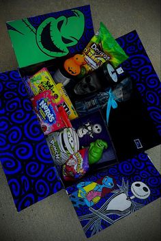 an assortment of candy and snacks laid out on a blue mat with black swirls