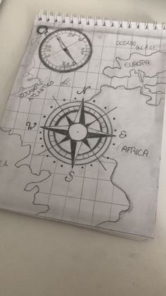 a notebook with a map and compass drawn on it