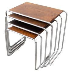 three metal and wood nesting tables stacked on each other