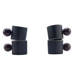 two black knobs are attached to the back of a pair of earring posts