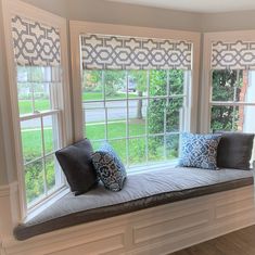 a window seat with two pillows on it