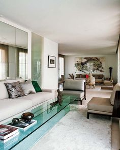 a living room filled with furniture and a glass coffee table