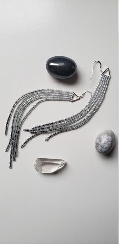 You know those gray, fuzzy leaved plants that are in almost everyone's gardens in the summer? These are named after them! Tiny silver, gray and charcoal lined beads are woven onto tiny silver plated earrings. These delicate strands hang at a full 5 inches and hold true to their shoulder duster name. Sparkling from top to bottom, these make a subtle but notable statement. finished with Sterling silver ear wires. Handwoven Earrings, Dusty Miller, Dusters, Colorful Earrings, Lightweight Earrings, Earrings Long, Delicate Earrings, Seed Bead Earrings, Fringe Earrings