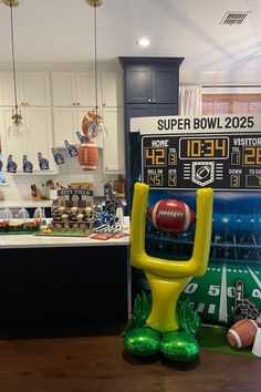 an inflatable football sitting on top of a table next to a scoreboard